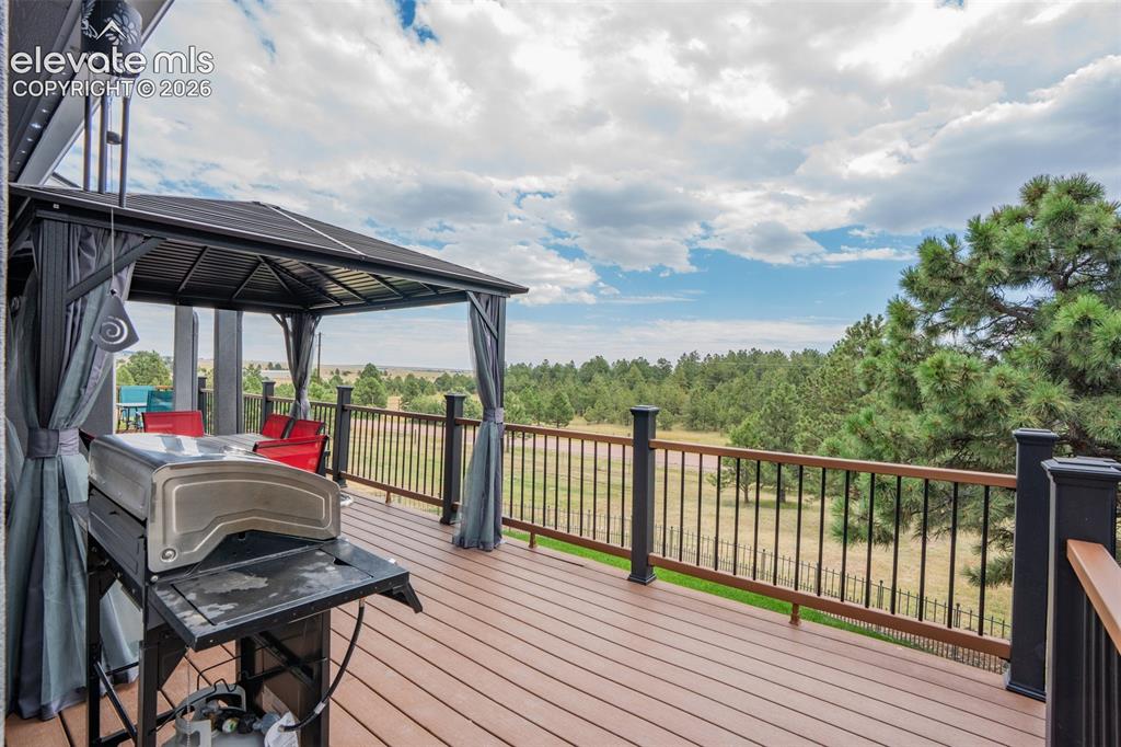 17370 Sweet Road Peyton, CO 80831 - Photo 12 of 38 44x20 newer no maintenance deck gives you the space to relax and enjoy your views; deck encompasses the front and side of the home, pergola is included with purchase.