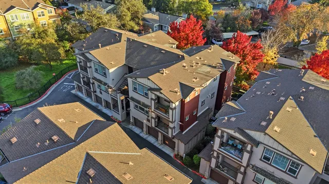 an aerial view of a house with a yard