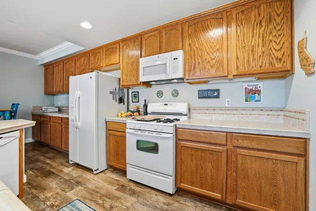 a kitchen with stainless steel appliances granite countertop a refrigerator sink and cabinets