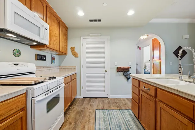 a kitchen with a sink stove and cabinets