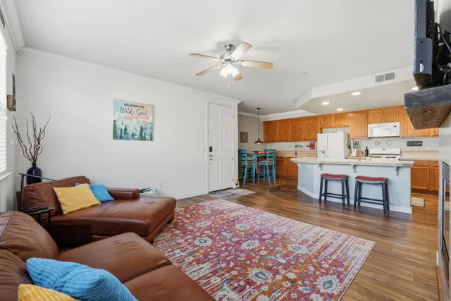 a living room with furniture and wooden floor