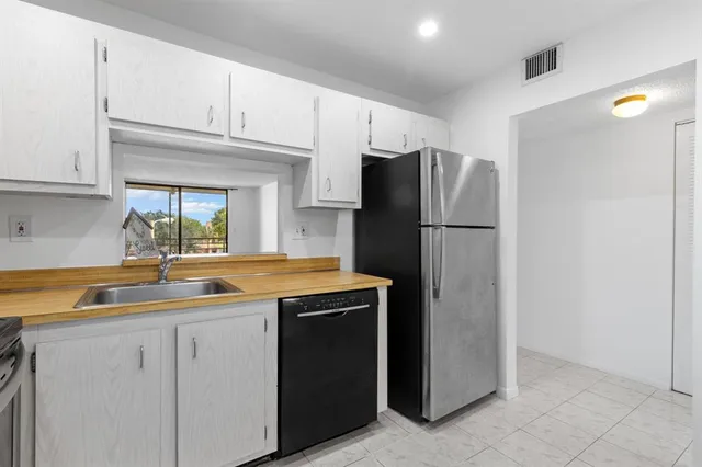 a kitchen with a sink and a refrigerator