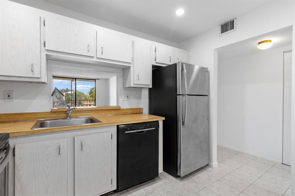 1830 Southwest 81st Avenue, Unit 4317 North Lauderdale, FL 33068 - Photo 5 of 22 a kitchen with stainless steel appliances granite countertop a refrigerator and a sink