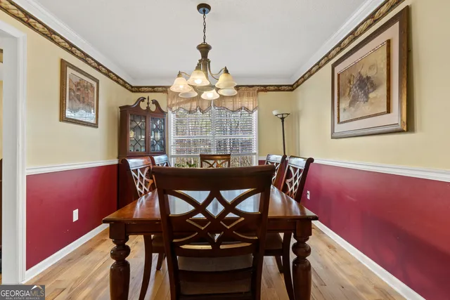 a dining room with a table and chairs