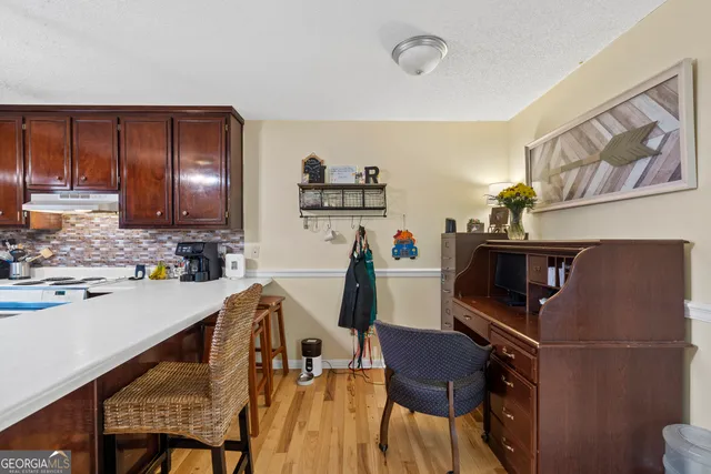 a kitchen with a sink a stove and cabinets