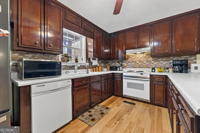a kitchen with a stove top oven sink and cabinets