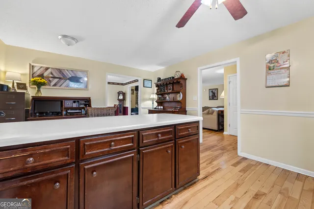 a kitchen with stainless steel appliances granite countertop a stove a sink dishwasher and a refrigerator with wooden cabinets