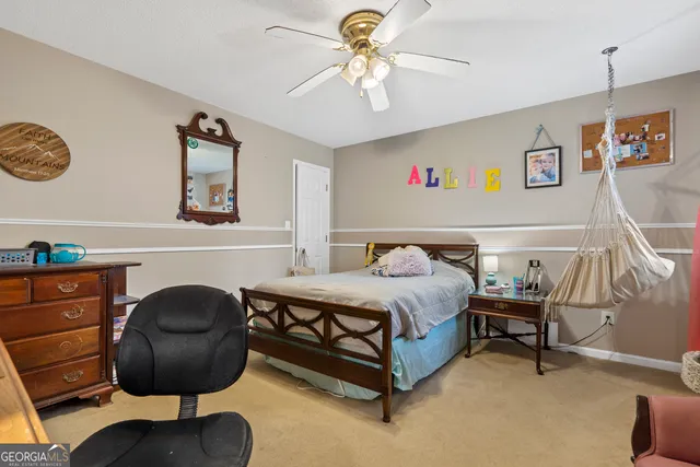 a bedroom with a bed window and a desk