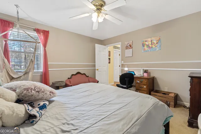 a bed room with a bed and a chair