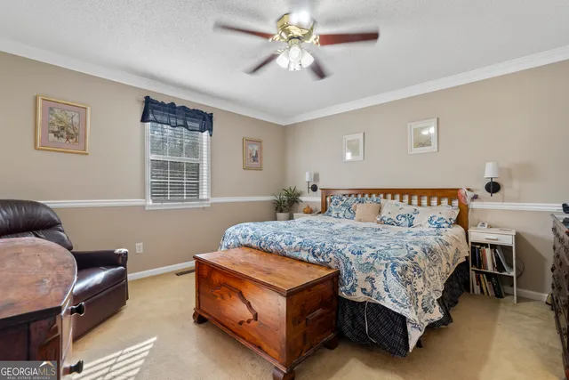 a bedroom with a bed and a dresser in it