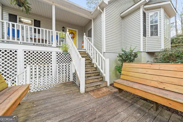 a view of a wooden deck with a white fence