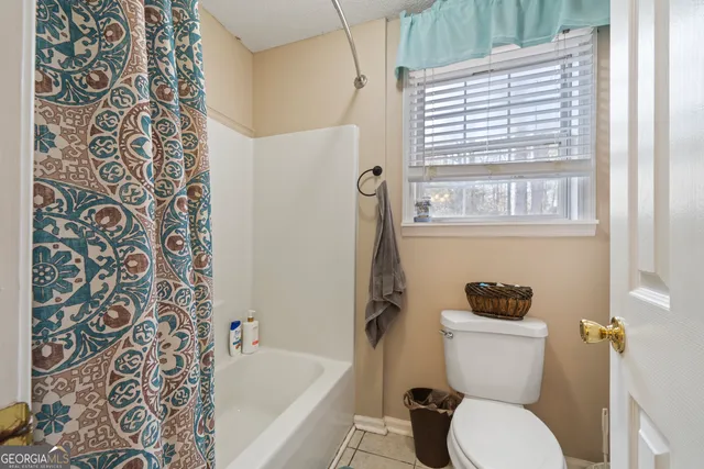 a living room with lots of furniture and white walls