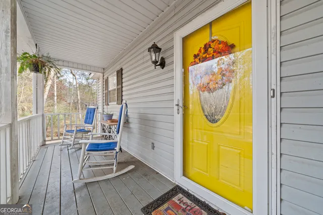 a view of sitting area in balcony with wooden floor
