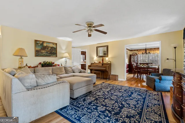 a living room with furniture flat screen tv and a window