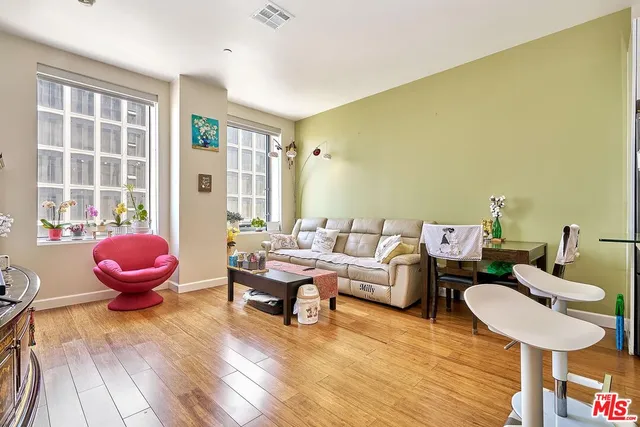a living room with furniture a table and chair