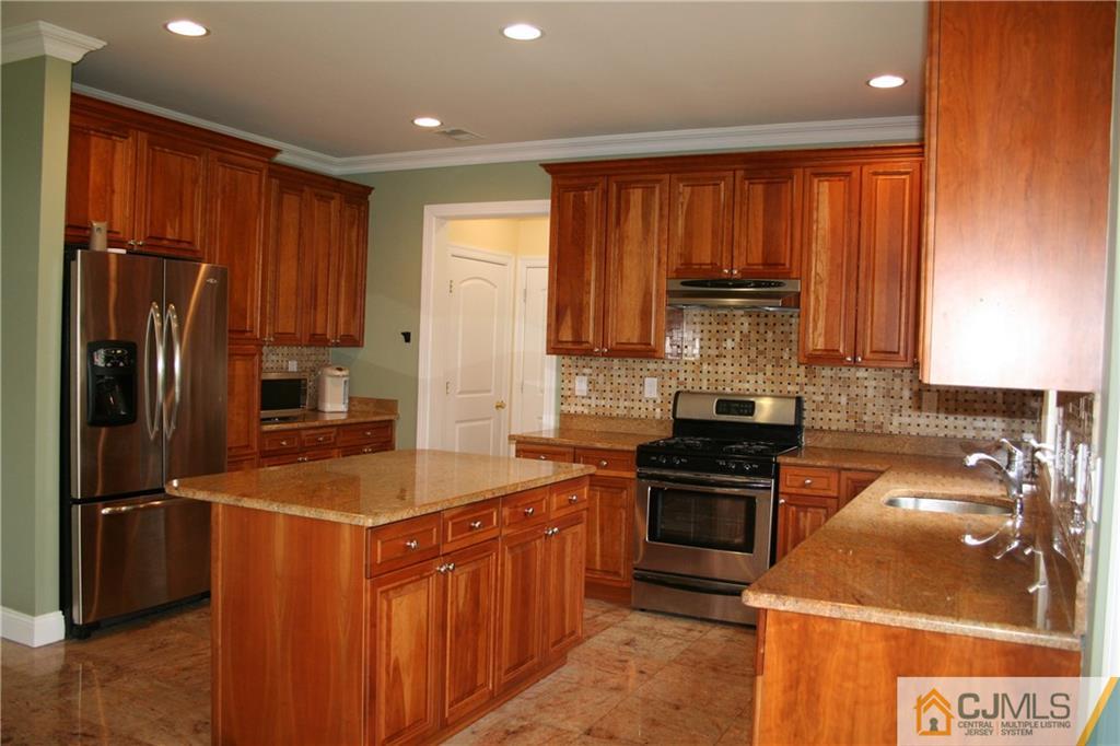 28 Chandler Road Edison, NJ 08820 - Photo 12 of 25 a kitchen with stainless steel appliances granite countertop a refrigerator stove and sink
