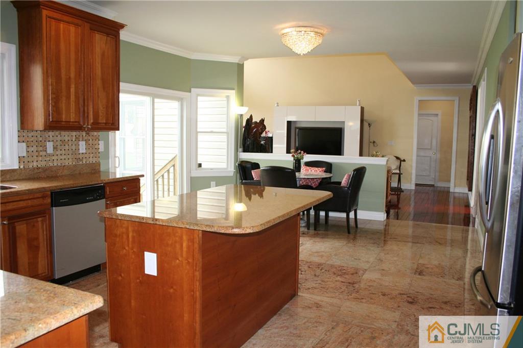 28 Chandler Road Edison, NJ 08820 - Photo 14 of 25 a dining room with kitchen island granite countertop furniture and a flat screen tv