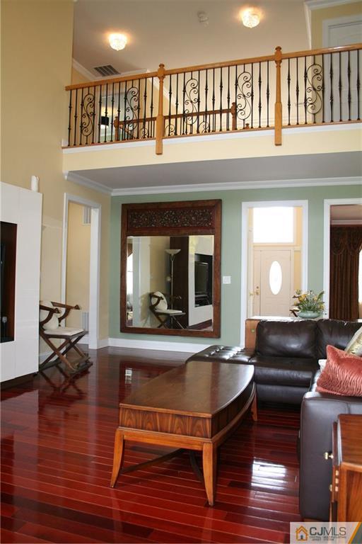 28 Chandler Road Edison, NJ 08820 - Photo 16 of 25 a living room with a couch a rug and a large window