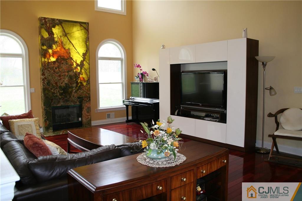 28 Chandler Road Edison, NJ 08820 - Photo 17 of 25 a living room with furniture a flat screen tv and a large window
