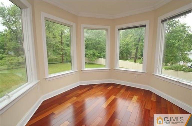28 Chandler Road Edison, NJ 08820 - Photo 20 of 25 a view of an empty room with wooden floor and a window