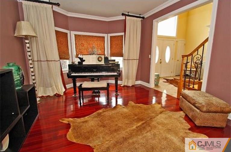 28 Chandler Road Edison, NJ 08820 - Photo 6 of 25 a living room with furniture a large window and wooden floor