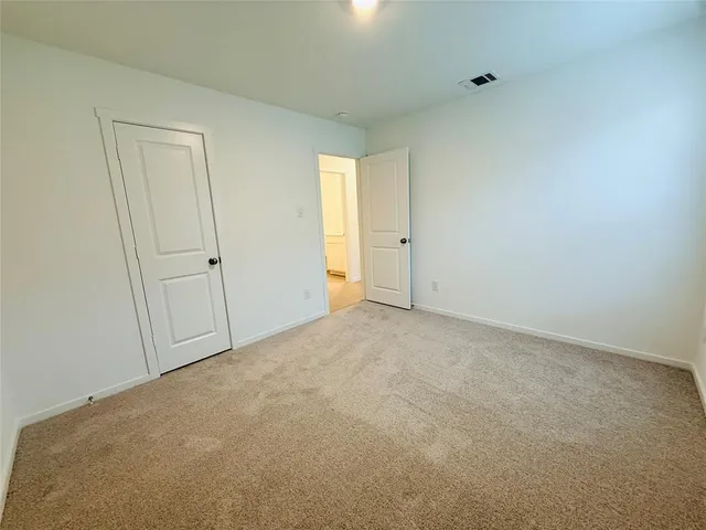 a view of an empty room and a window
