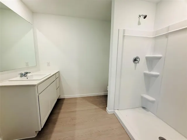 a bathroom with a double vanity sink a toilet and a mirror