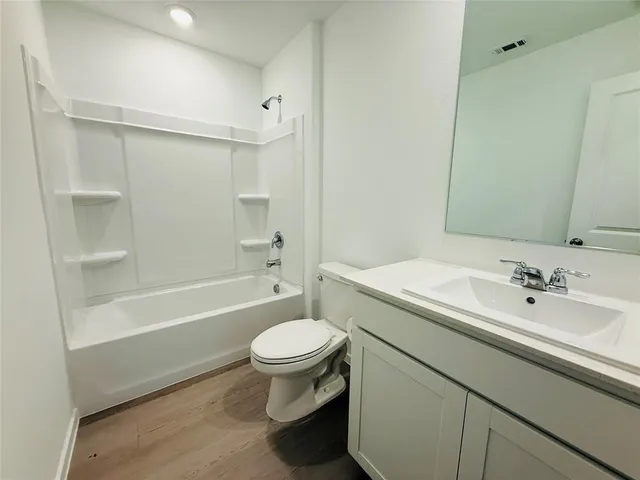 a bathroom with a sink toilet a mirror and shower