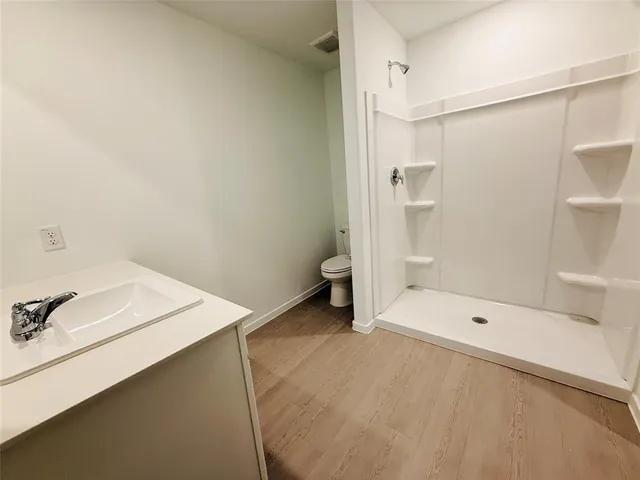 a bathroom with a shower and a sink