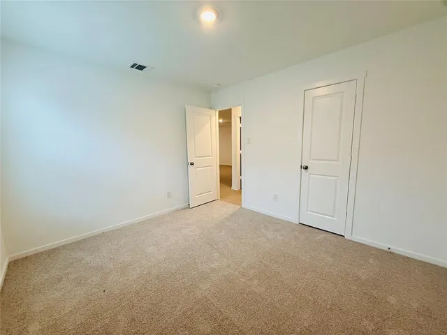 a view of an empty room and closet area