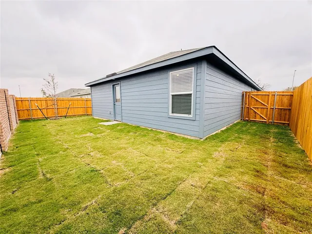 a view of a backyard of the house