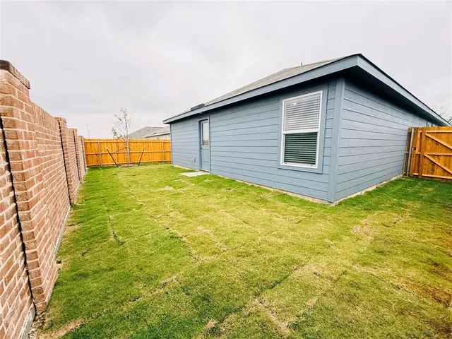 a view of a backyard of the house
