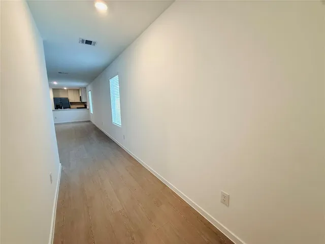 a view of a big room with wooden floor and stairs