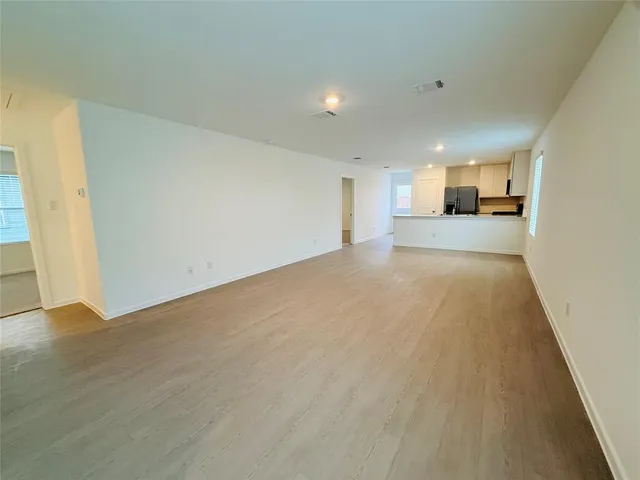 a view of a kitchen with a sink and a refrigerator