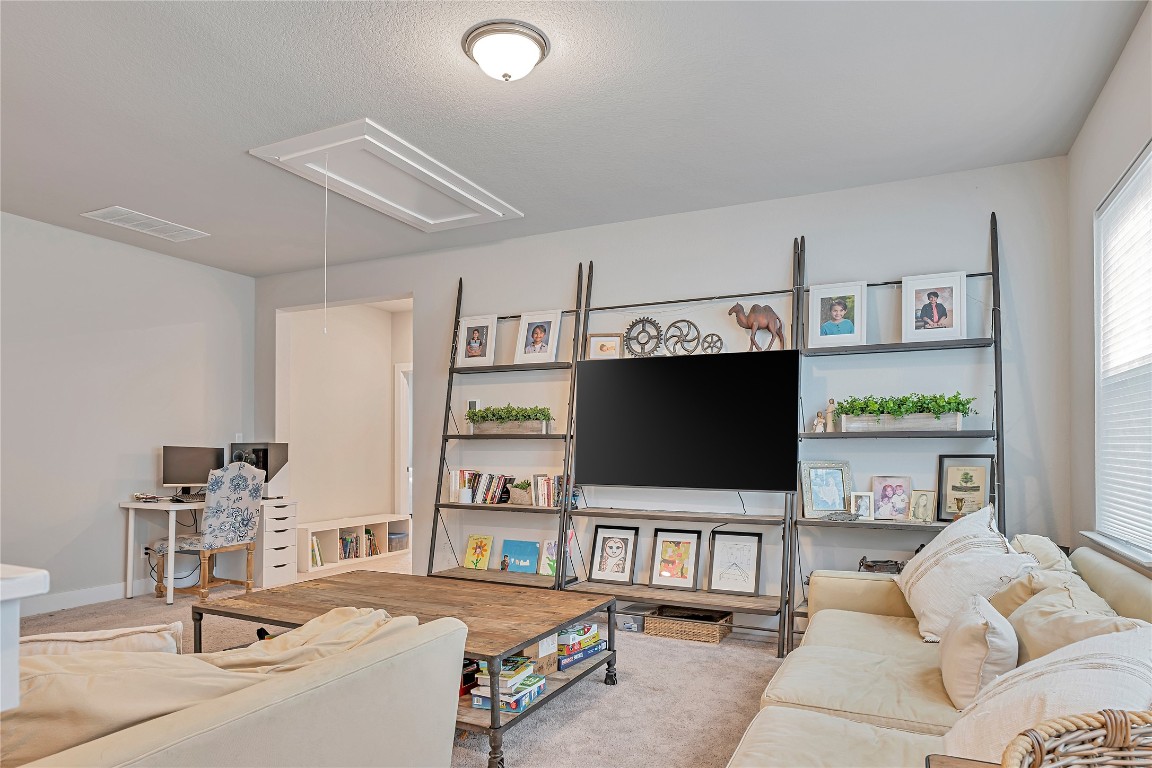 175 Brooks Ranch Drive Kyle, TX 78640 - Photo 11 of 30 a living room with furniture and a flat screen tv