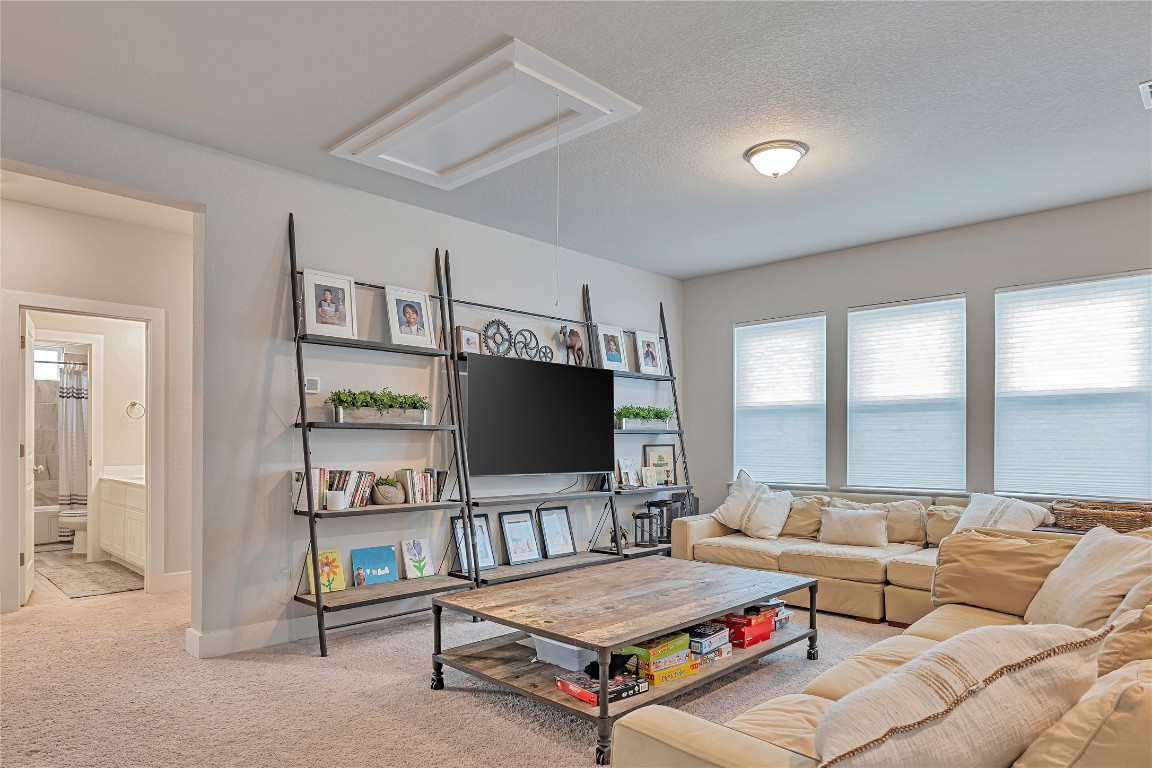 175 Brooks Ranch Drive Kyle, TX 78640 - Photo 12 of 30 a living room with furniture and a flat screen tv
