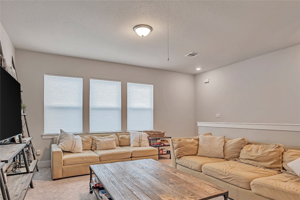 175 Brooks Ranch Drive Kyle, TX 78640 - Photo 14 of 30 a living room with furniture and a flat screen tv