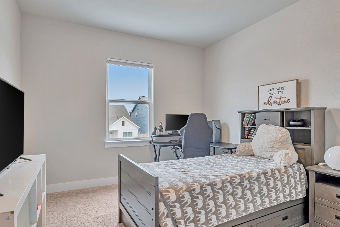 175 Brooks Ranch Drive Kyle, TX 78640 - Photo 20 of 30 a bedroom with a bed and a dresser in it