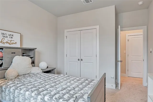 a bedroom with a bed and a cabinets