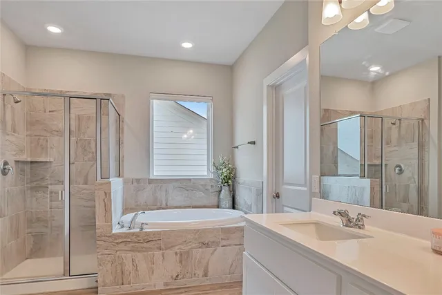 a bathroom with a tub sink and mirror