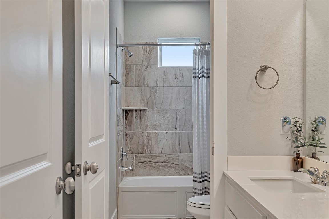 175 Brooks Ranch Drive Kyle, TX 78640 - Photo 25 of 30 a bathroom with a granite countertop sink toilet and shower