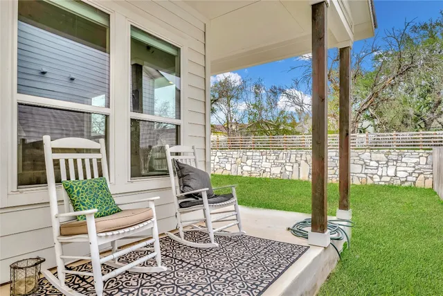 a view of a patio with a table chairs and backyard