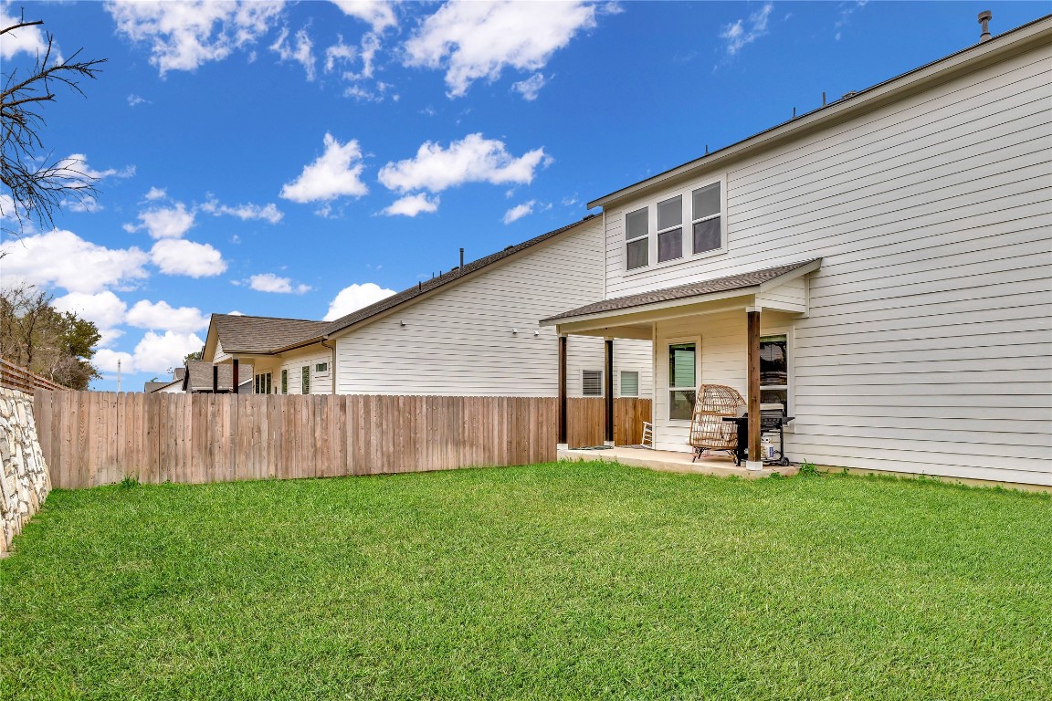 175 Brooks Ranch Drive Kyle, TX 78640 - Photo 28 of 30 a front view of a house with garden and yard