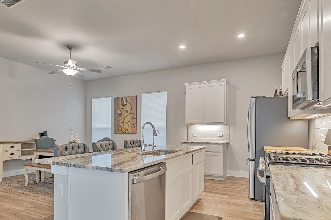 175 Brooks Ranch Drive Kyle, TX 78640 - Photo 6 of 30 a kitchen with a sink cabinets and window