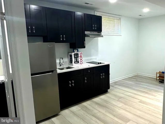 a kitchen with a sink and a refrigerator