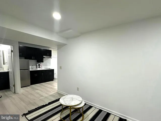 a living room with a couch and a view of bathroom