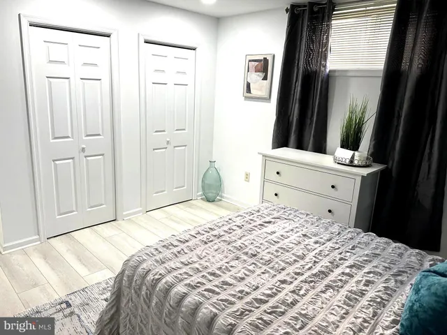 a bedroom with a bed and a large mirror