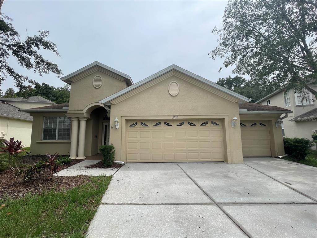 3530 Fiddlers Green Loop Wesley Chapel, FL 33544 - Photo 1 of 1 a view of a house with a yard and large tree