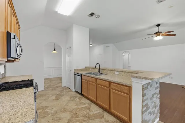 a bathroom with a granite countertop sink a toilet and a mirror
