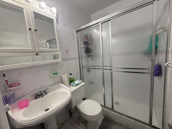 a white toilet sitting next to a bathroom sink